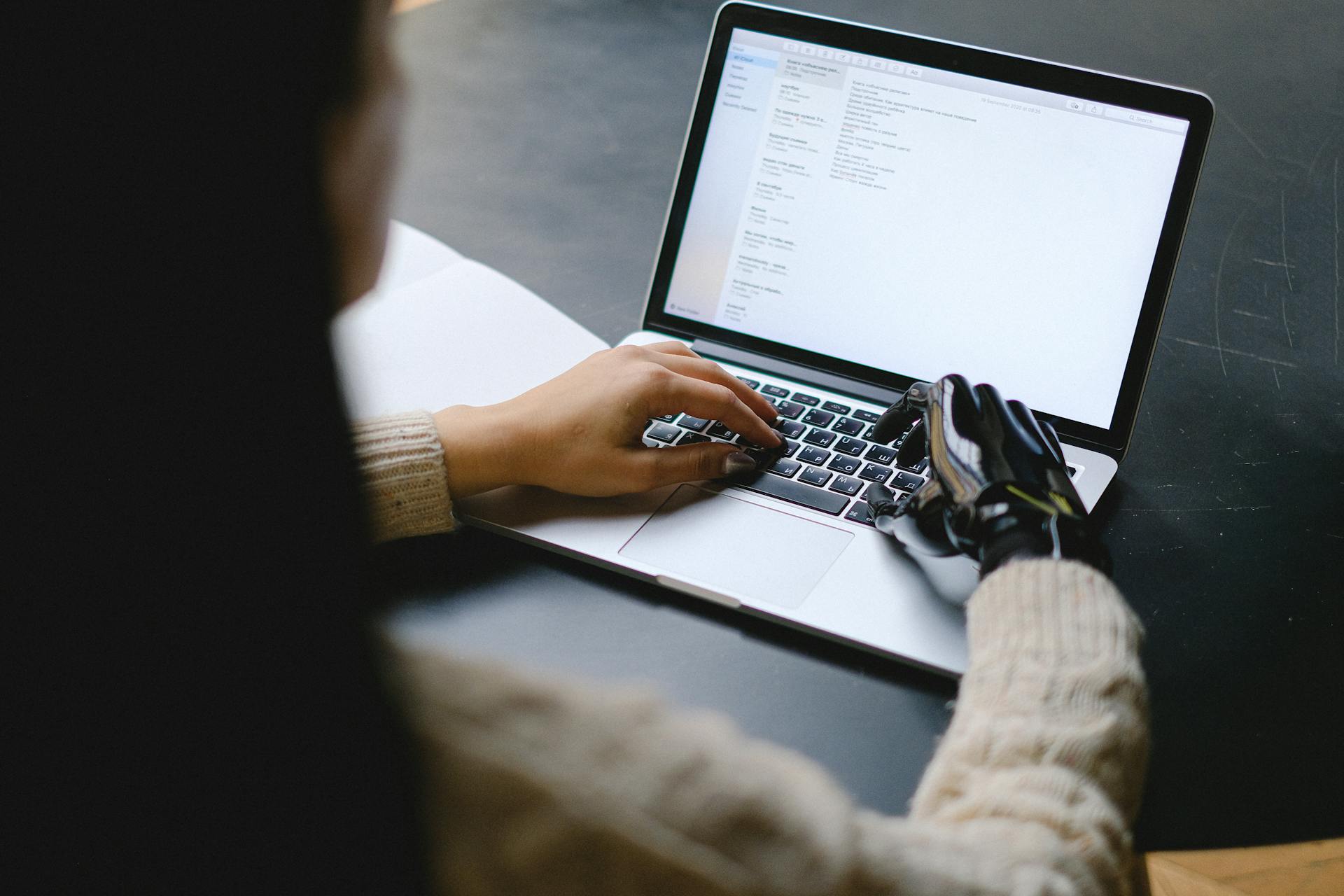 Woman writing on laptop using AI writing tool